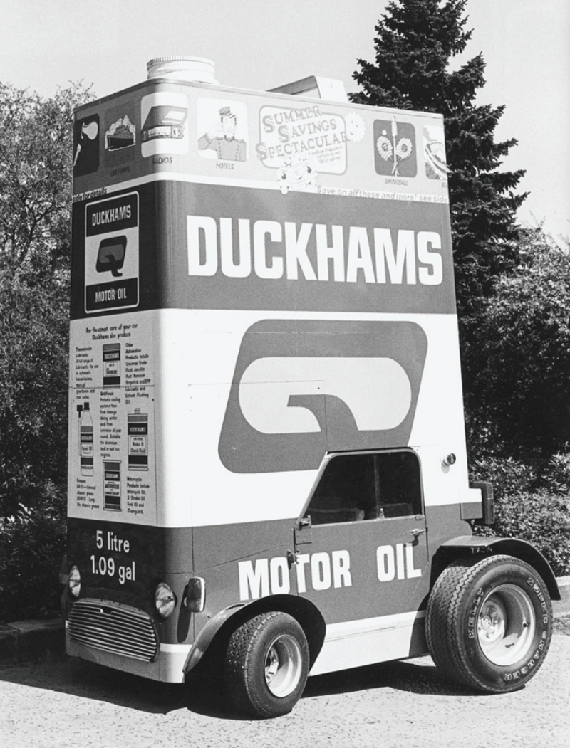 A vintage black and white photograph of the unique Duckhams promotional 'Q car', built to look exactly like a giant 5-litre motor oil tin on wheels.