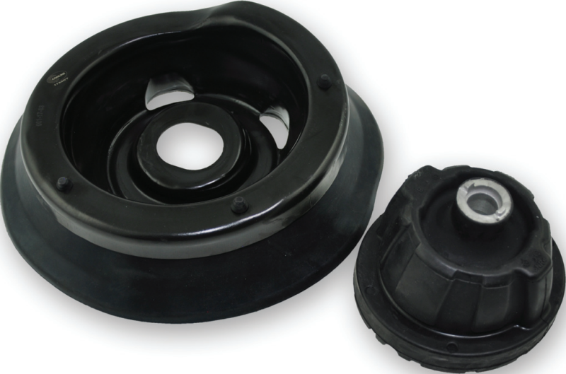 A close-up shot of the underside of a black rubber-to-metal bonded Comline top strut mount alongside a smaller matching component piece.