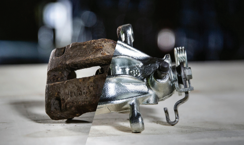 A split comparison image showing an automotive brake caliper core, with the left half heavily rusted and the right half completely remanufactured and shiny.