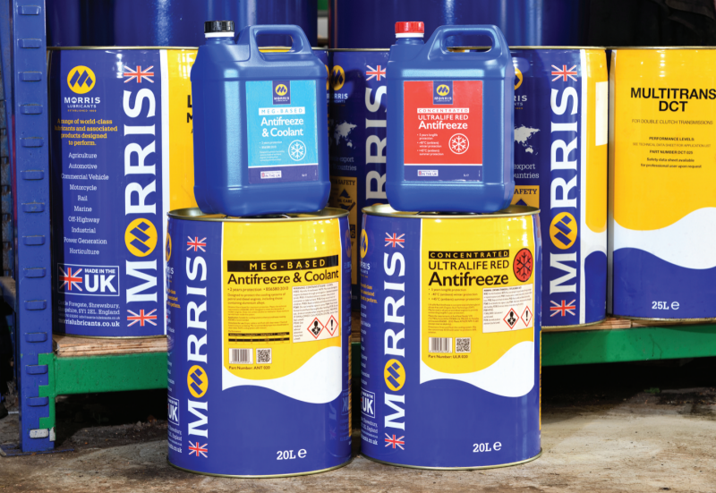 Collection of Morris Lubricants antifreeze and coolant products, including MEG-Based and Concentrated Ultralife Red formulations, stacked in 5L containers and 20L drums on workshop shelving.